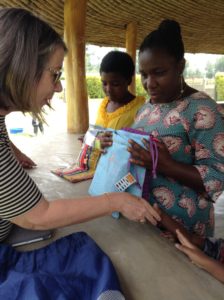 A Partnership in Caring volunteer Lynn MacDonald distributing and explaining the Days for Girls kits